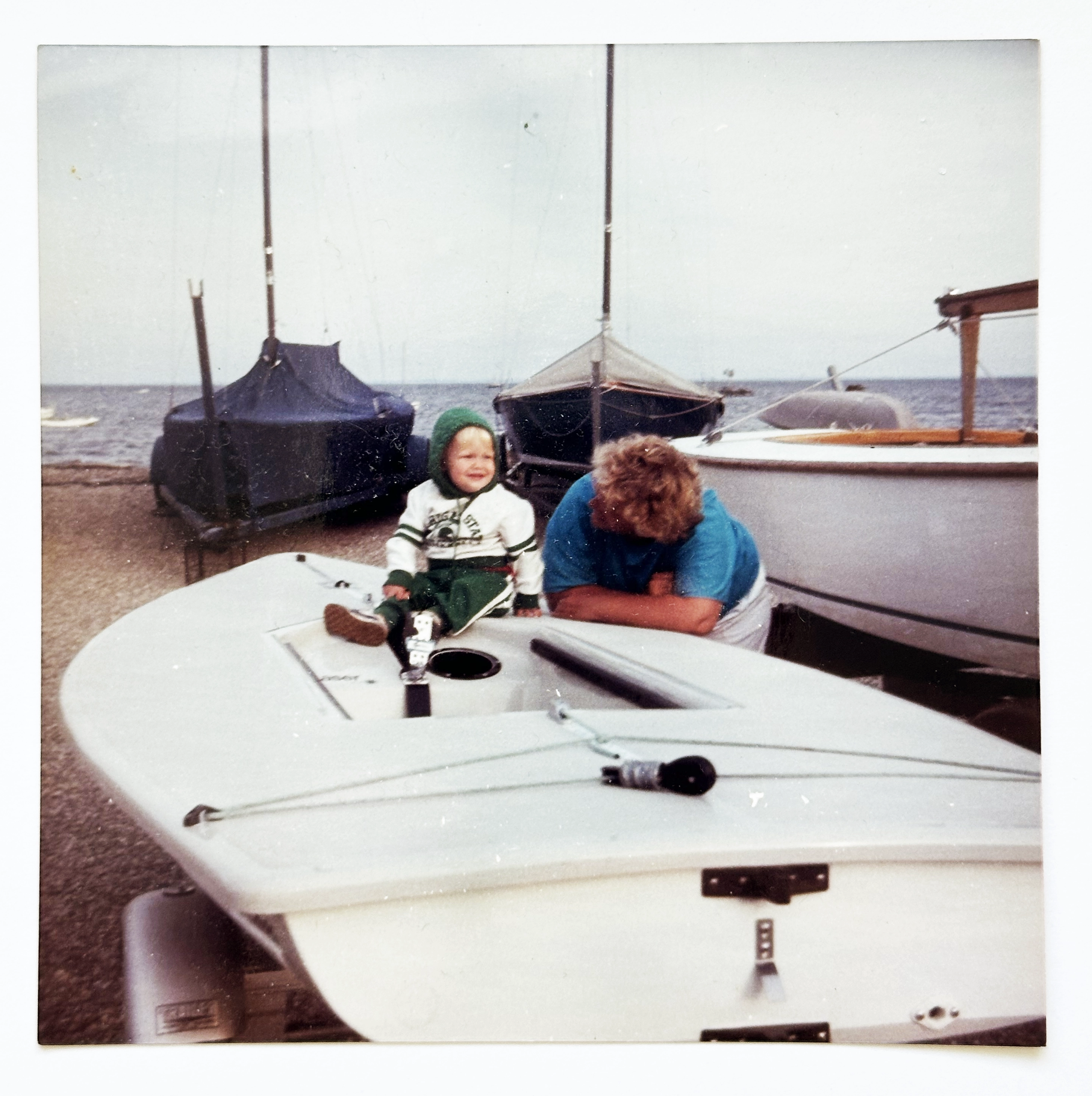 Andrew Sorensen as a baby on a Laser dinghy at the yacht club with his Aunt Jody